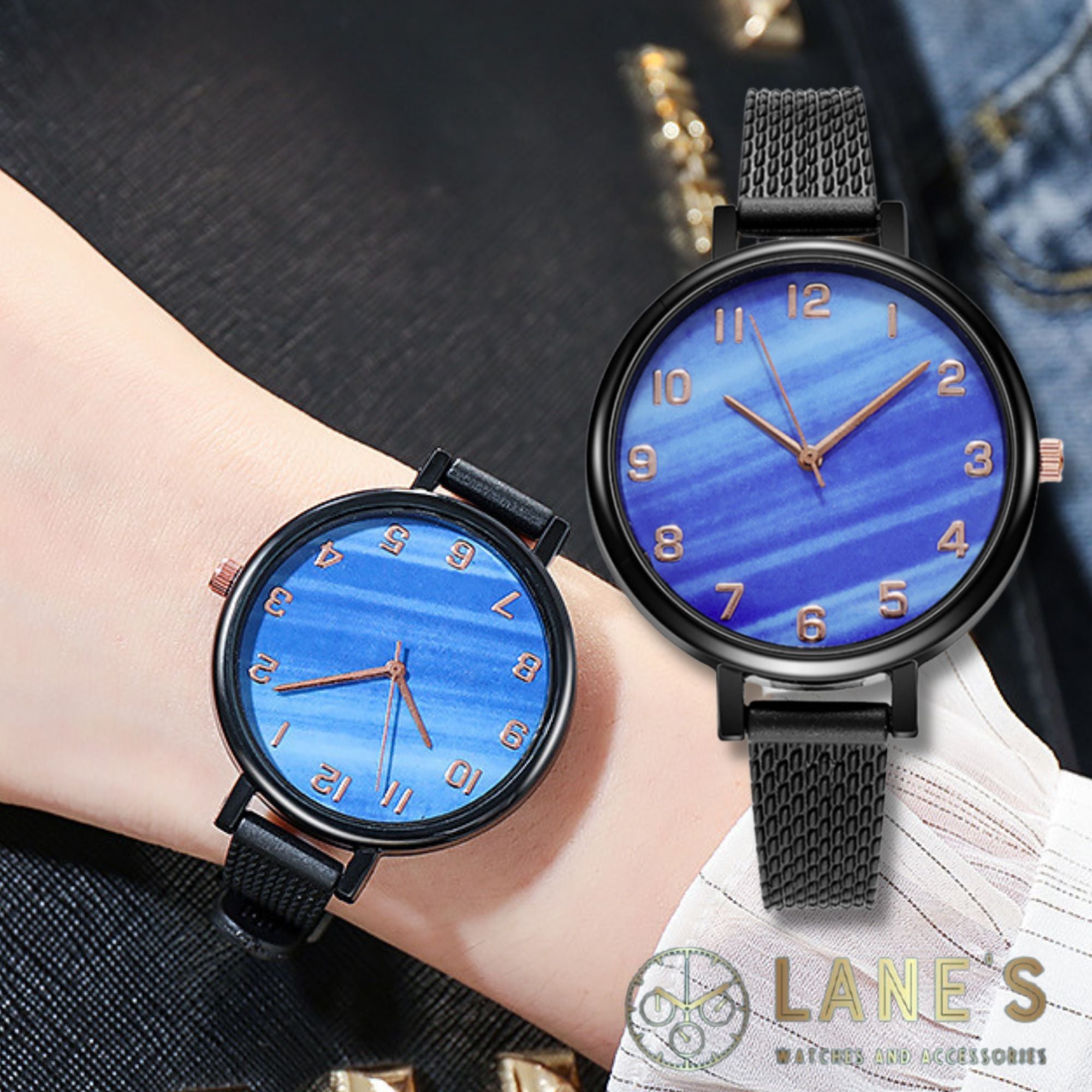 blue faced watch with gold numbers and a black trim with a black strap on a woman's wrist