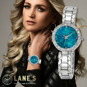 glittery blue faced watch with a crystal trim and a silver chain strap glittery blue faced watch with a crystal trim and a silver chain strap on a woman's wrist