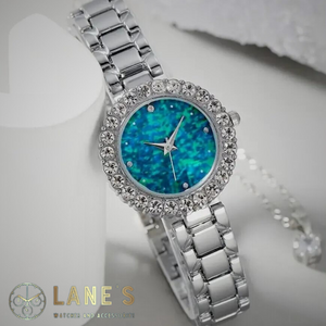 glittery blue faced watch with a crystal trim and a silver chain strap 