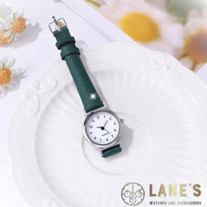 Green Meadow Ladies watch. Green strap, white face with silver trim. Numbers in black 1-12 with hour minute and second hands