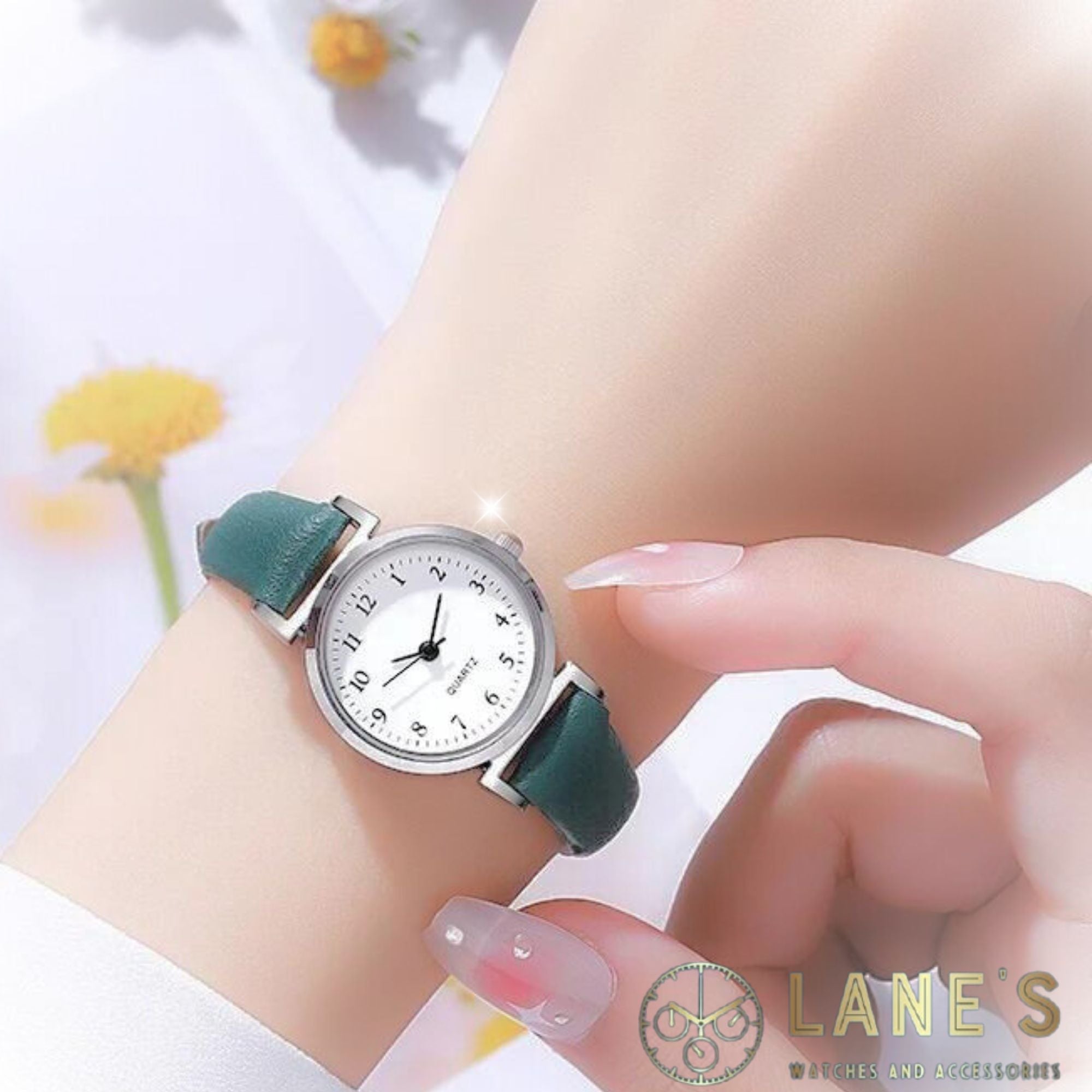 Green Meadow Ladies watch. Green strap, white face with silver trim. Numbers in black 1-12 with hour minute and second hands