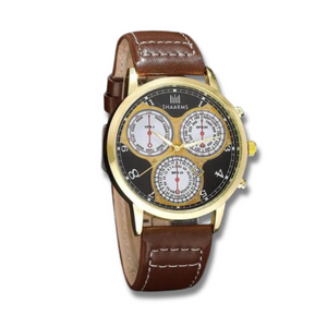 3 different clock faces on a black faced watch with white numbers and gold hands with a gold trim and a brown leather strap 