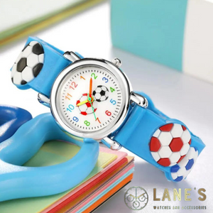 small football watch with a white face with colourful numbers and 2 small footballs in the middle with a silver trim and blue strap with footballs