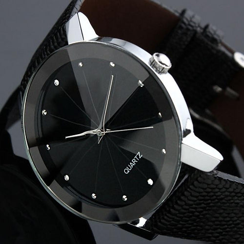 black faced watch with a shaped glass with a point with crystal dots representing the numbers with a silver trim and a black strap with a grey background