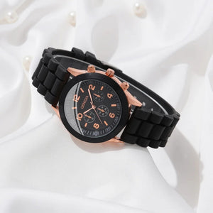 black faced watch with rose gold numbers counting up in twos with a black trim with rose gold edging with a rubbery black strap